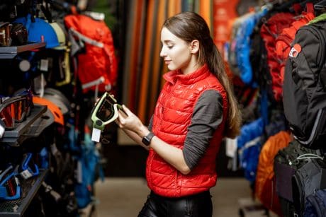 Woman looking on the sports equipment in the shop