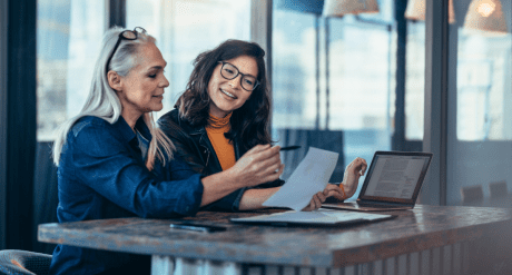 two women analyzing documents in office - concept for compliance trends july 2025