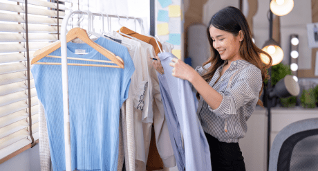 Fashion designer with clothes - concept for textiles regulations