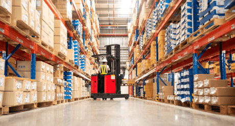 worker in warehouse moving packages on forklift - concept for Extended Producer Responsibility for Packaging